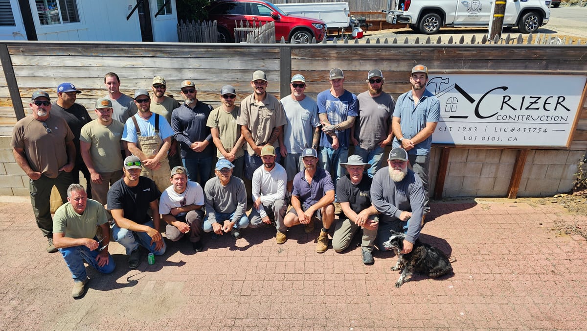 The Crizer Construction field crew in front of the company sign in Los Osos.